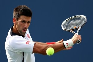 NEW YORK, NY - SEPTEMBER 08:  Novak Djokovic of Serbia returns a shot during his men's singles semifinal match against David Ferrer of Spain on Day Thirteen of the 2012 US Open at USTA Billie Jean King National Tennis Center on September 8, 2012 in the Flushing neighborhood of the Queens borough of New York City.  (Photo by Clive Brunskill/Getty Images)