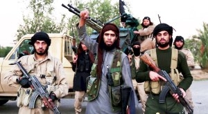 A man (C) identified in the subtitiles as Al Karar the Iraqi gestures as he speaks at an undisclosed location in this image taken from undated video footage released by Islamic State. Islamic State warned in the new video on November 16, 2015 that countries taking part in air strikes against Syria would suffer the same fate as France, and threatened to attack in Washington. The video, which appeared on a site used by Islamic State to post its messages, begins with news footage of the aftermath of Friday's Paris shootings in which at least 129 people were killed. REUTERS/Social Media Website via Reuters TVATTENTION EDITORS - THIS PICTURE WAS PROVIDED BY A THIRD PARTY. REUTERS IS UNABLE TO INDEPENDENTLY VERIFY THE AUTHENTICITY, CONTENT, LOCATION OR DATE OF THIS IMAGE. THIS PICTURE IS DISTRIBUTED EXACTLY AS RECEIVED BY REUTERS, AS A SERVICE TO CLIENTS. FOR EDITORIAL USE ONLY. NOT FOR SALE FOR MARKETING OR ADVERTISING CAMPAIGNS. NO RESALES. NO ARCHIVE.