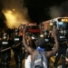 Police officers wearing riot gear block a road during protests after police fatally shot Keith Lamont Scott in the parking lot of an apartment complex in Charlotte, North Carolina, U.S. September 20, 2016. REUTERS/Adam Rhew/Charlotte Magazine   MANDATORY CREDIT. FOR EDITORIAL USE ONLY. NO RESALES. NO ARCHIVES.     TPX IMAGES OF THE DAY