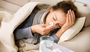 Sick Woman. Flu. Woman Caught Cold. Sneezing into Tissue