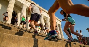 In this may 25, 2016 photo, members of the running group "November Project" run up and down the stairs of the Lincoln Memorial, in Washington. Fitness buffs around the country are bringing the ‘take the stairs’ advice to a whole new level as noteworthy landmarks have become unlikely, yet popular new workout sites. (AP Photo/Andrew Harnik)