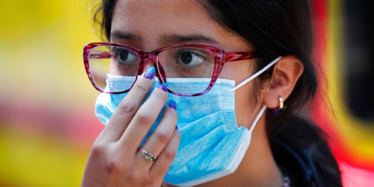 A teen wears a medical mask as a precaution against the spread of the new coronavirus, during an outing in Mexico City, Saturday, Feb. 29, 2020. Mexico’s Health Department said late Friday that a new case had been confirmed in Mexico City, adding to the first two confirmed cases announced earlier that day.  (AP Photo/Marco Ugarte)