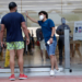 An employee wearing a protective face covering, right, monitors the flow of customers at an Apple retail store along Lincoln Road Mall during the new coronavirus pandemic, Wednesday, June 17, 2020, in Miami Beach, Fla. (AP Photo/Lynne Sladky)