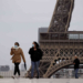 People walk near the Eiffel Tower, in Paris, Monday, May 11, 2020. The French began leaving their homes and apartments for the first time in two months without permission slips as the country cautiously lifted its lockdown. Clothing stores, coiffures and other businesses large and small were reopening on Monday with strict precautions to keep the coronavirus at bay. (AP Photo/Christophe Ena)