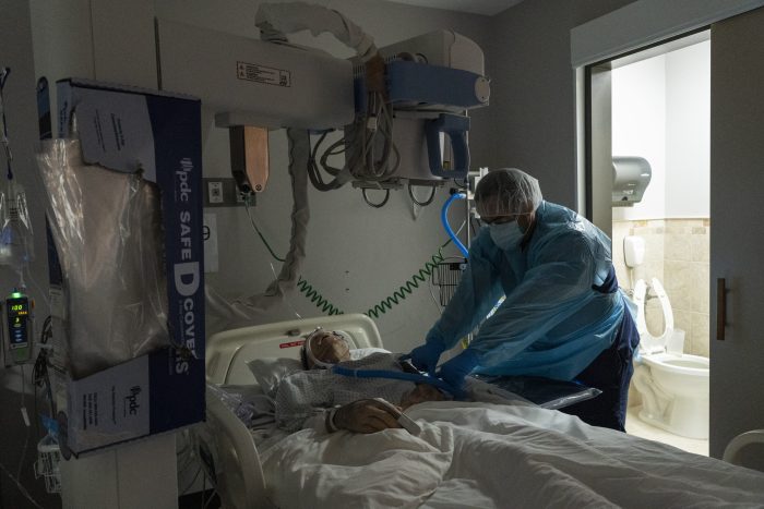 HOUSTON, TX - DECEMBER 28: (EDITORIAL USE ONLY) Medical staff member Khang Nguyen prepares to take an Xray of a patient in the COVID-19 intensive care unit (ICU) at the United Memorial Medical Center on December 28, 2020 in Houston, Texas. According to reports, Texas has recorded more than 1,710,000 coronovirus cases, including more than 27,100 deaths.   Go Nakamura/Getty Images/AFP