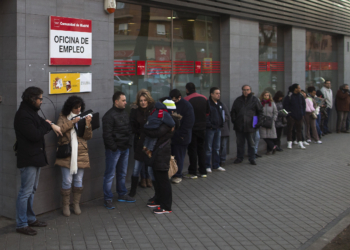 People wait in line to enter an unemployment registry office in Madrid, Spain, Thursday, Jan. 23, 2014.